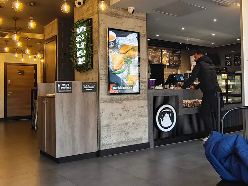 Slimline Pro advertising display by Add Vision showing digital signage with vibrant graphics on a sleek, modern frame.
